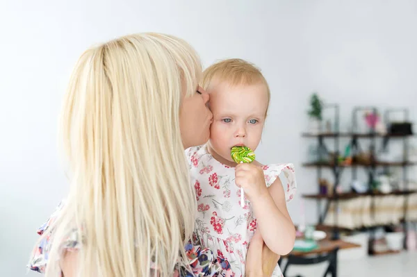 Mother kissing her baby's. Mother holding infant's. Portrait of a mother with baby at home. — Stock Photo, Image