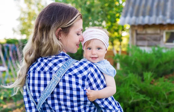 Happy mother and baby daughter outdoors — Stock Photo, Image