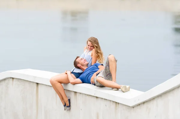 Happy young couple spending time outdoors on a summer day in a city park.