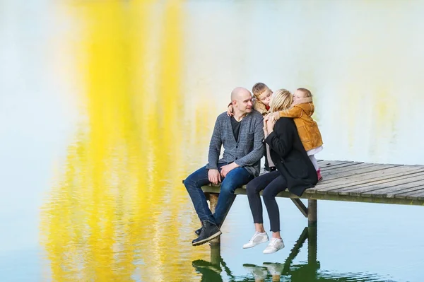 Família passar o tempo juntos junto ao lago no outono. Beijos de família gentis. Fim de semana de outono ao ar livre . — Fotografia de Stock
