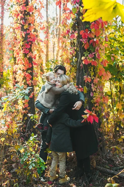 Familia feliz. Padre, madre e hijos en el parque de otoño . — Foto de Stock