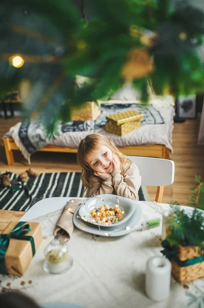 Chica feliz sentado en la cocina con plato de comida sabrosa . —  Fotos de Stock