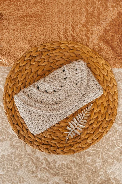 Small knitted ladies' purse of beige color.