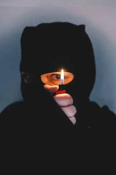 Beautiful desperate scared frightened young muslim woman wearing black hijab holding the lighter. — Stock Photo, Image