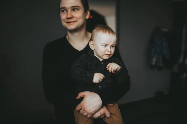 Le jeune père tenant son bébé pleuré dans ses mains. Gros plan — Photo