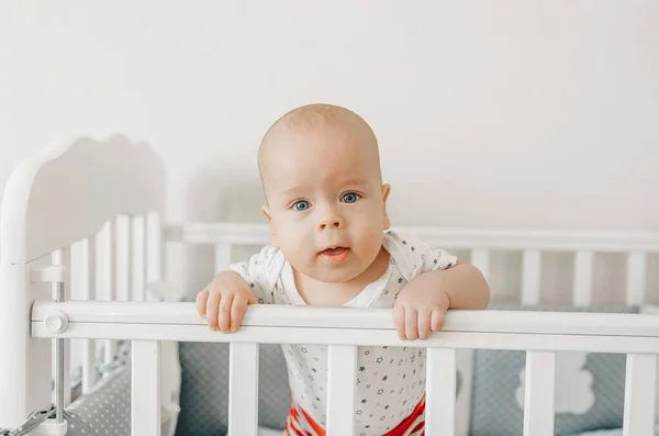 Closeup portrait of a happy baby in a bed — Stock Photo, Image