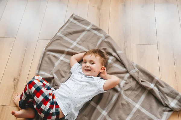 Top view of cute happy little boy looking at camera. — Stock Photo, Image