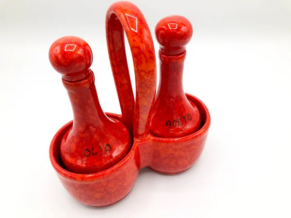 Salt and pepper dispenser in a red porcelain