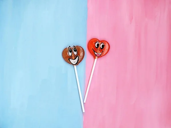 Two lollipops on pink and blue background. Love concept. Valentines day — Stock Photo, Image