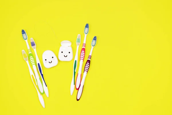 Toothbrushes Dental Floss Yellow Background — Stock Photo, Image