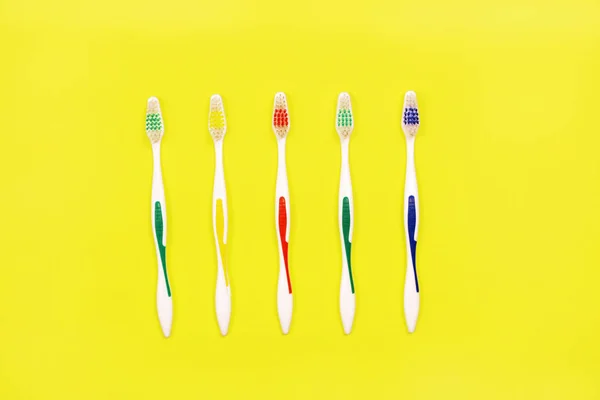 Toothbrushes on yellow background