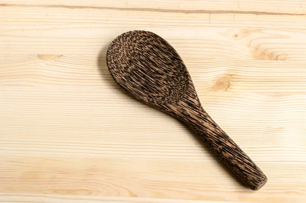 Serving spoons on wooden surface