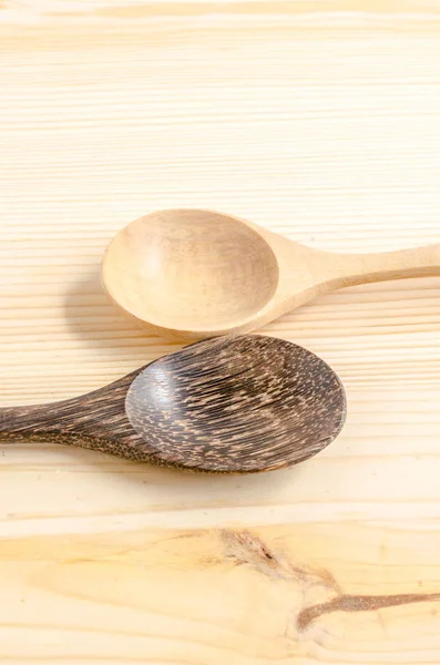 Wooden kitchen spoons on wooden table