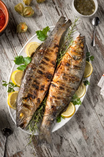 Ikan laut panggang disajikan di atas piring — Stok Foto