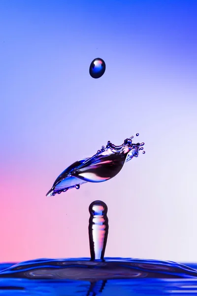 Water Druppel Botsing Een Gekleurde Achtergrond — Stockfoto