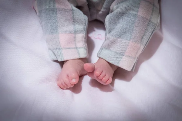 tiny feet of newborn baby