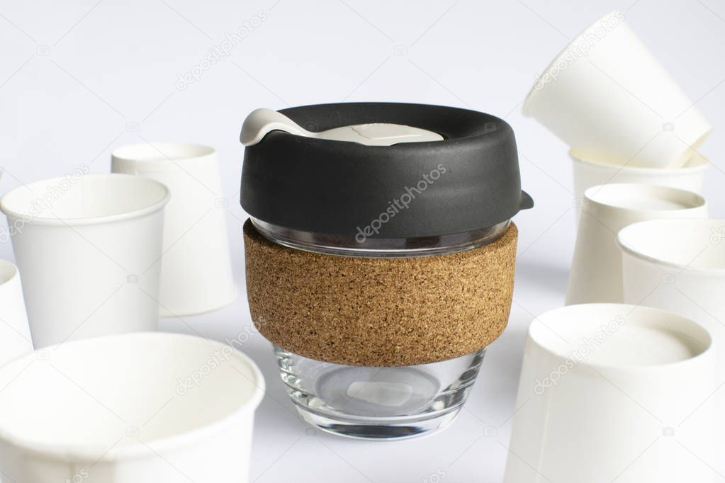 Reusable Coffee Eco Cup. Toughened Glass Cup & Natural Cork Band. Secure silicon lid. Reusable eco cup on the background of disposable cups. Eco-Friendly, Spill Proof Travel Mug with Lid | Black