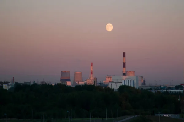 moon in the evening over the power plant