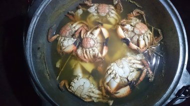 Crabs are boiled in a tourist pot at the stake