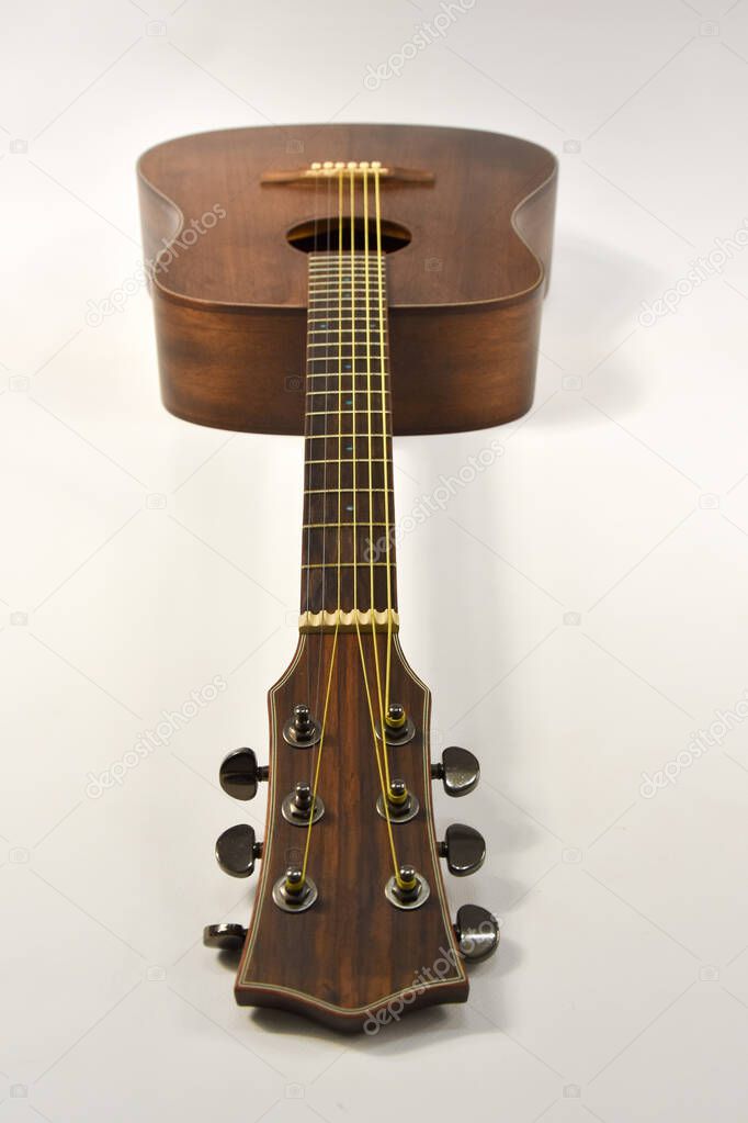 beautiful acoustic six-string guitar on a white background