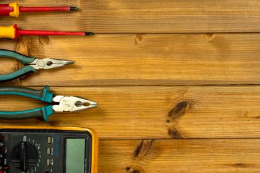 Tahta arka planda fotokopi alanı olan elektrikli bir alet. Üst Manzara. Düz yatıyordu