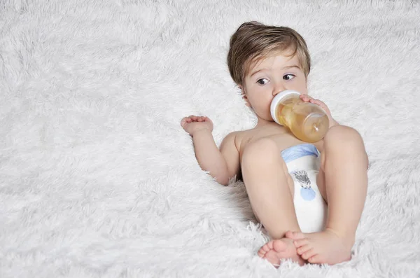 Baby drinking from a bottle — Stock Photo, Image