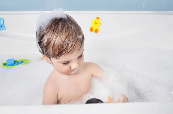 small child takes a bath