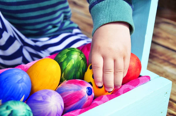 Huevos de Pascua brillantes en una cesta de colores . — Foto de Stock