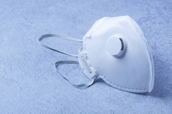 Yeniden kullanılamayan steril beyaz fp3 kapakçıklı bir maske, covid-19 corona virüsü, h1n1, h5n1 gibi virüslere karşı koruma olarak kullanılabilir.