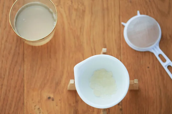 A flatlay overhead water kefir drink and kefir grains. Concept of healthy living organic drink, homemade, diy, gut health