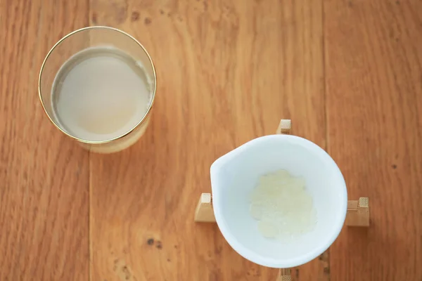 A flatlay overhead water kefir drink and kefir grains. Concept of healthy living organic drink, homemade, diy, gut health