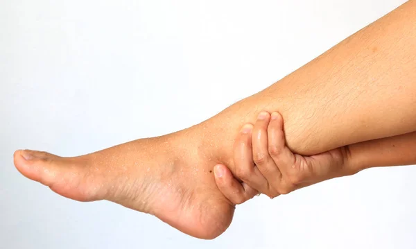 Woman hands leg massage for pain relief on a white background — Stock Photo, Image