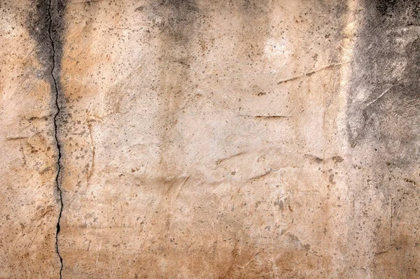 High-resolution photograph of a weathered wall surface.