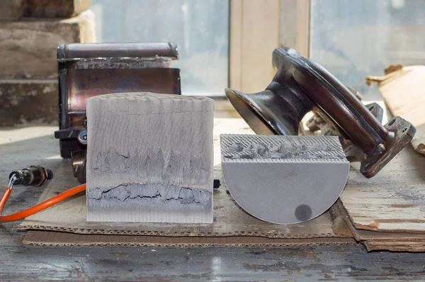 The catalytic converter of exhaust gases of the car, opened and cut into two parts, to demonstrate the damaged elements of the precincts