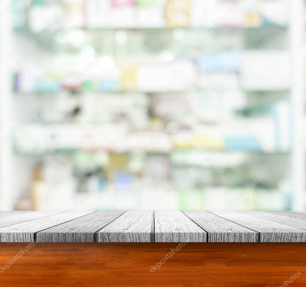 Soft white wooden table under blurred image of corridor and bokeh light background 