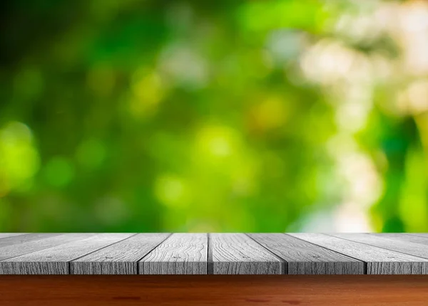 Mesa de madeira com fundo natureza borrada — Fotografia de Stock