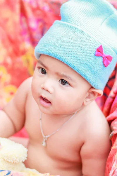 Cute baby with hood playing outdoors — Stock Photo, Image