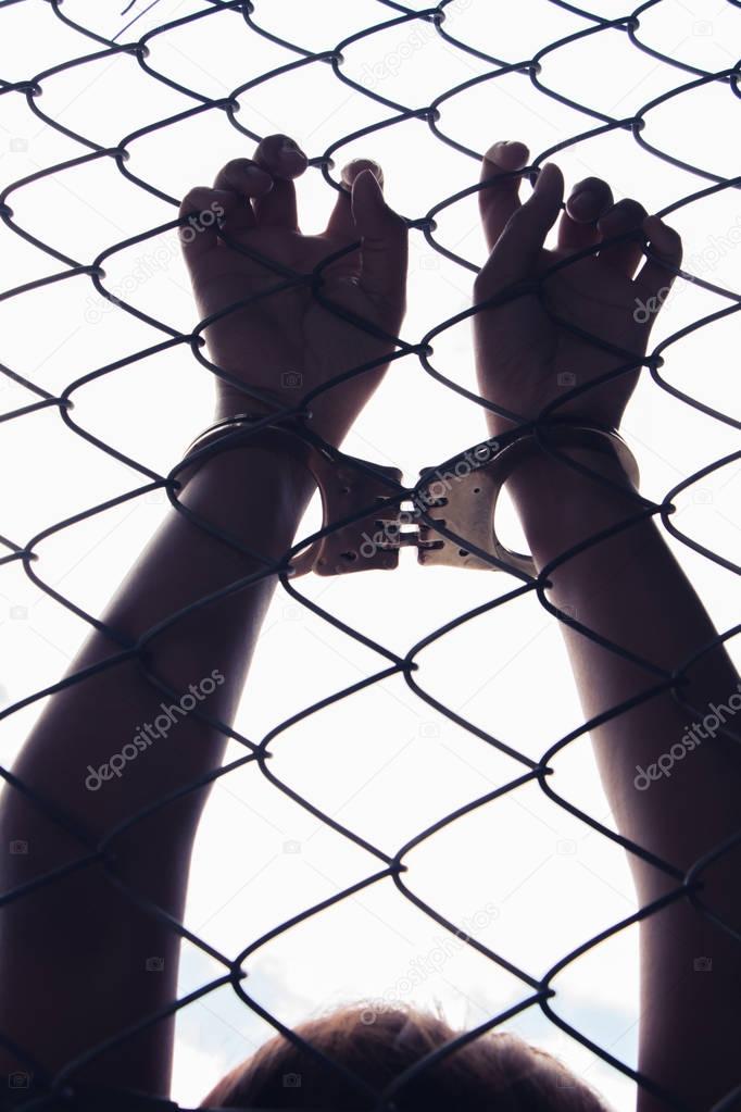 hand holding fence