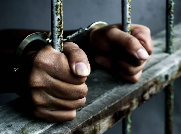 Prisoner holding metal cage — Stock Photo, Image