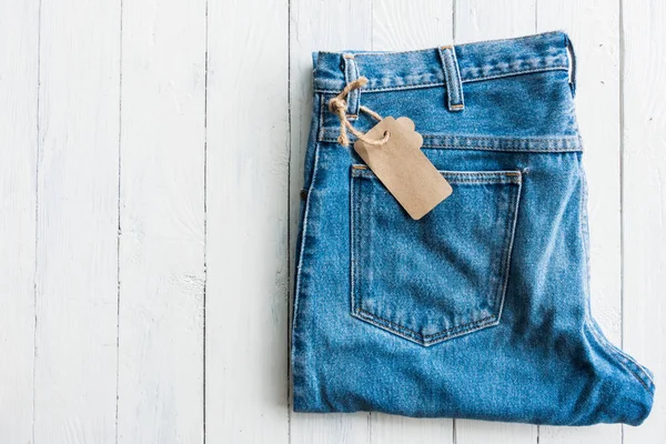 Närbild Denim Jeans Byxa Pålagd Vit Träbord — Stockfoto