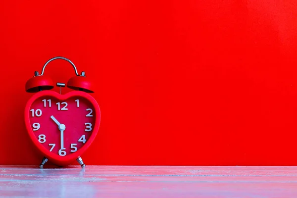 red alarm clock mark at 10.30 o\'clock