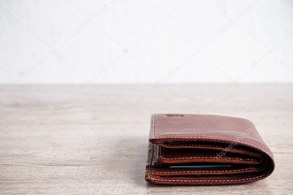 brown leather luxury wallet put on wooden