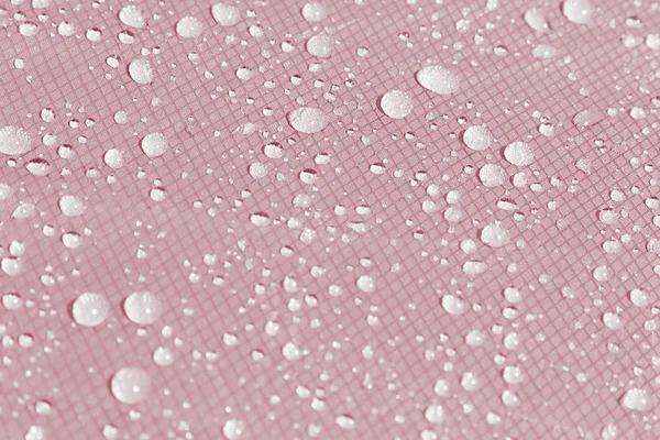 분홍색 배경에 물이 떨어진다. — 스톡 사진