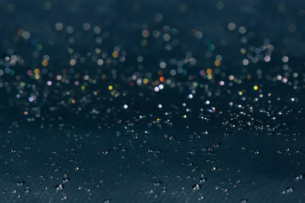 Water drops with rainbow glitter on a dark background. — Stock Photo, Image