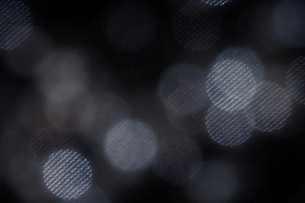 Bokeh cercles de maille blanc foncé sur fond noir . — Photo