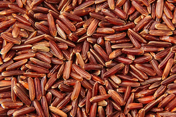 Arroz vermelho fundo close-up . — Fotografia de Stock