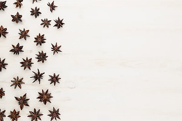 Anise stars spice pattern  on white wood background. — Stock Photo, Image