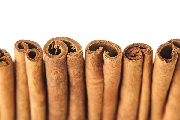 Cinnamon sticks closeup on white background.