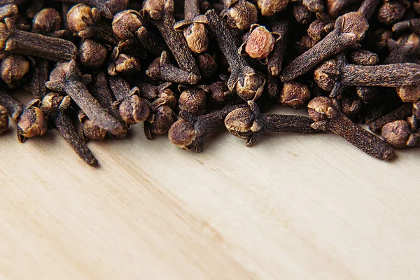 Clove spice closeup on wooden beige background. — Stock Photo, Image