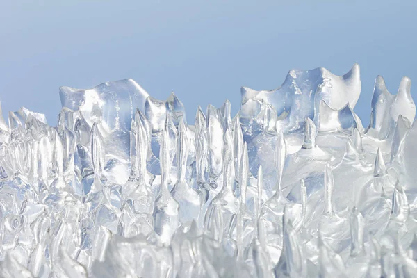 Whimsical surface ice closeup on blue sky background. — Stock Photo, Image